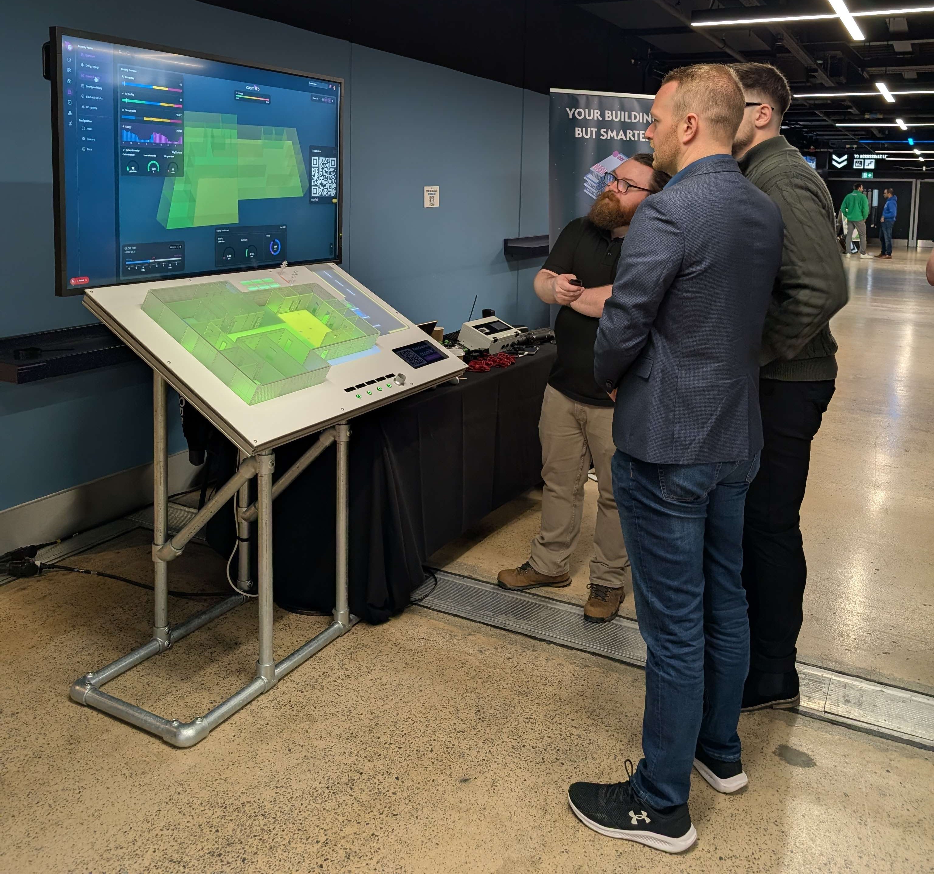 Visitors interacting with the cosmOS display during Manchester Green Tech events.
